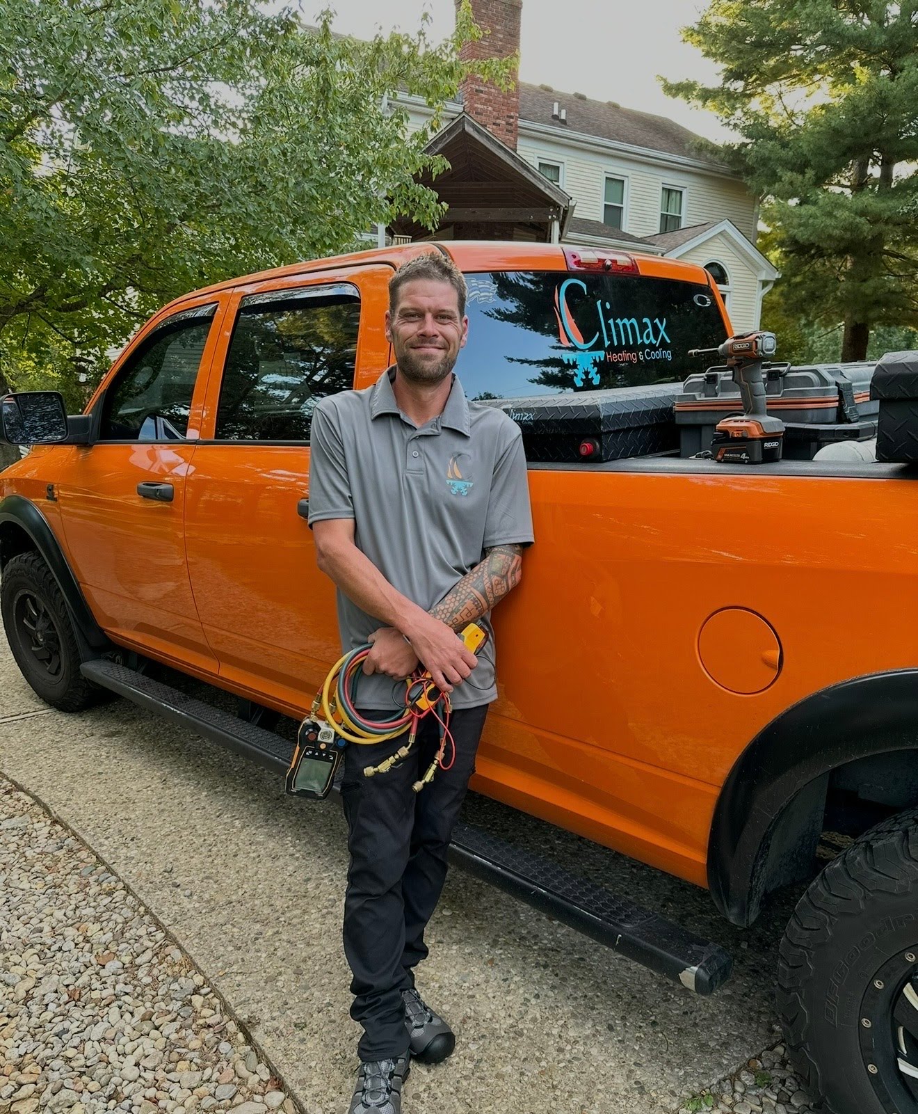 Brandon, owner of Climax Heating & Cooling, beside the company truck